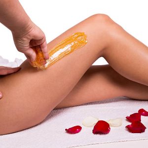 Sugaring: epilation with liquate sugar at legs.